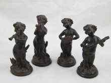 Appraisal: A set of four black ceramic putti playing mandolin pan