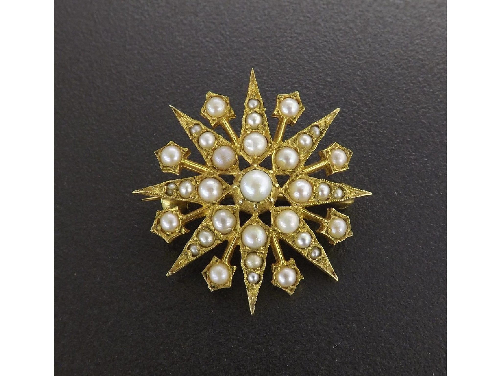 Appraisal: Decorative ct yellow gold split pearl set star brooch circa