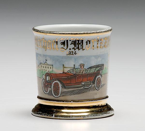 Appraisal: SHAVING MUG WITH EARLY AUTOMOBILE porcelain with polychrome painted scene