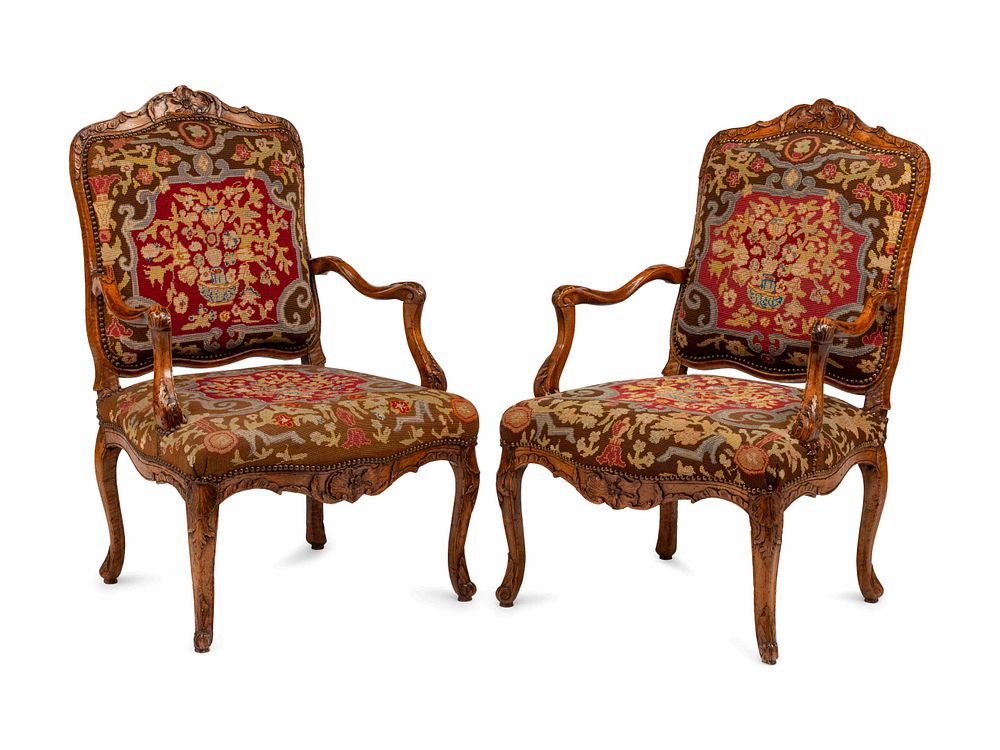 Appraisal: A Pair of Regence Walnut Needlepoint-Upholstered Fauteuils A Pair of