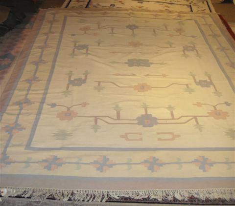 Appraisal: DHURRIE CREAM WITH PINK BLUE GREEN AND BROWN DESIGNED RUG