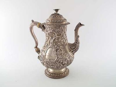 Appraisal: A George IV Scottish coffee pot profusely embossed and chased