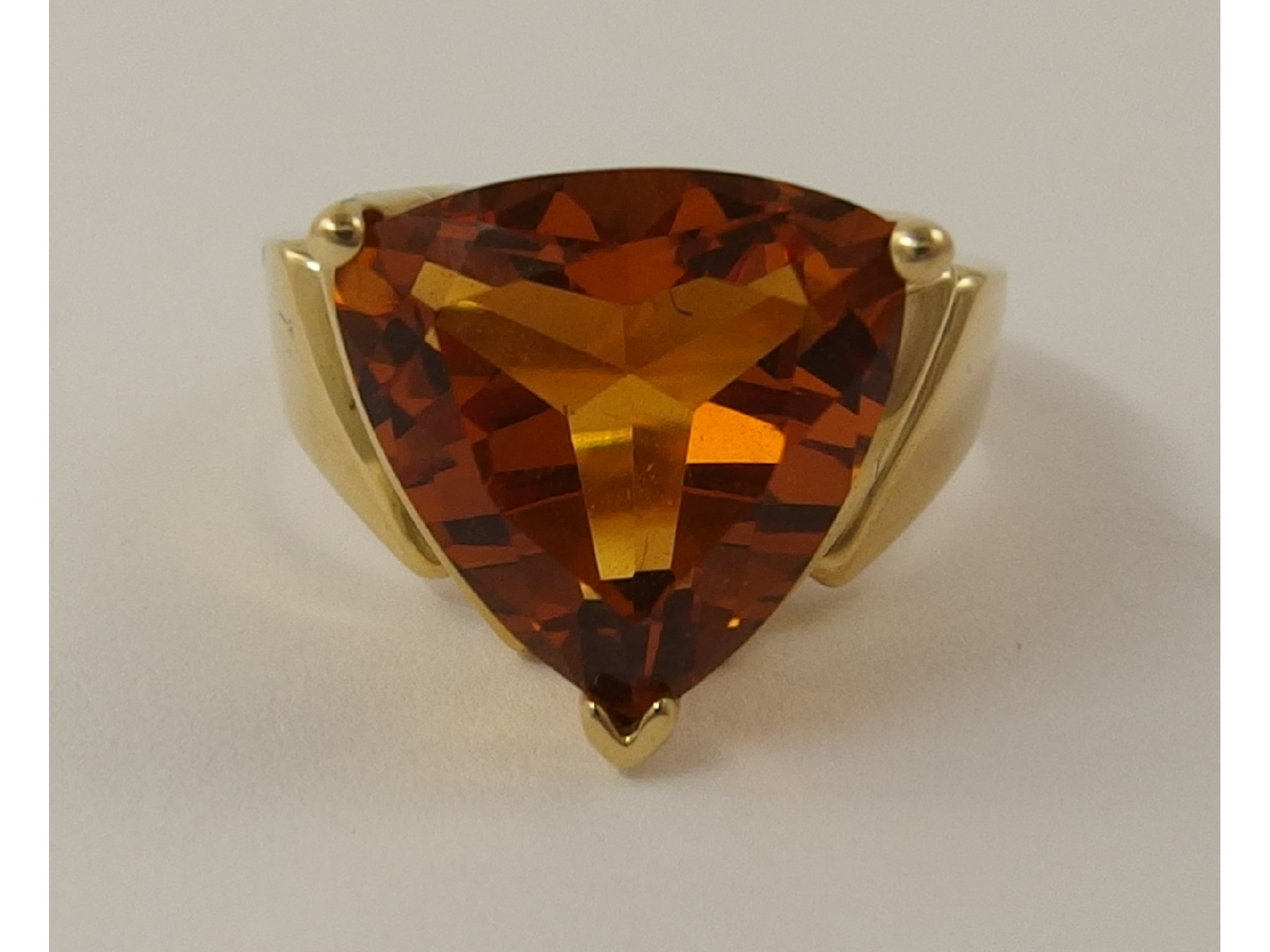 Appraisal: A k dress ring set with a trilliant cut orange