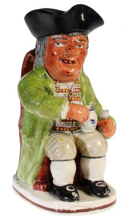 Appraisal: A STAFFORDSHIRE TOBY JUG the ruddy faced toper with several