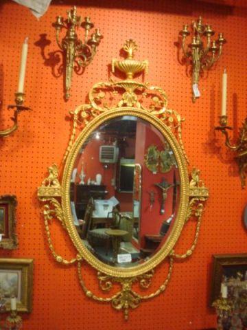 Appraisal: Ornate Oval Beveled Giltwood Mirror with Urn Form Crown From