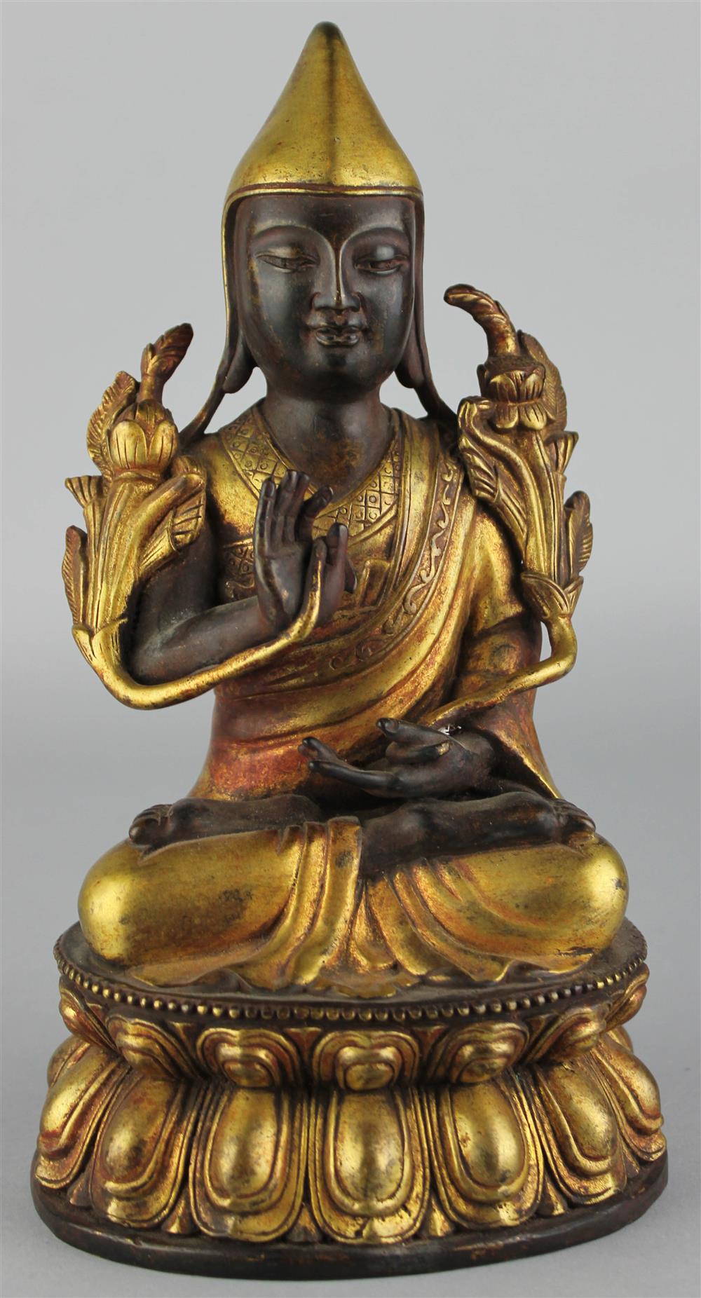 Appraisal: SINO-TIBETAN PARCEL GILT-BRONZE FIGURE OF A MONK the seated figure