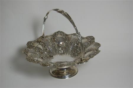 Appraisal: A late Victorian swing handled basket Sheffield the shallow bowl