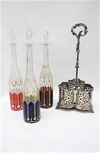 Appraisal: BOHEMIAN DECANTER SET SILVERED STAND c reticulated silverplated holder with