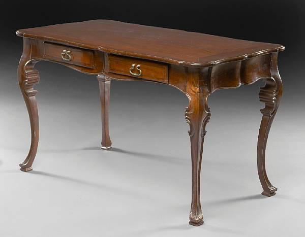 Appraisal: A Portuguese Rococo style walnut writing table The cartouche shaped