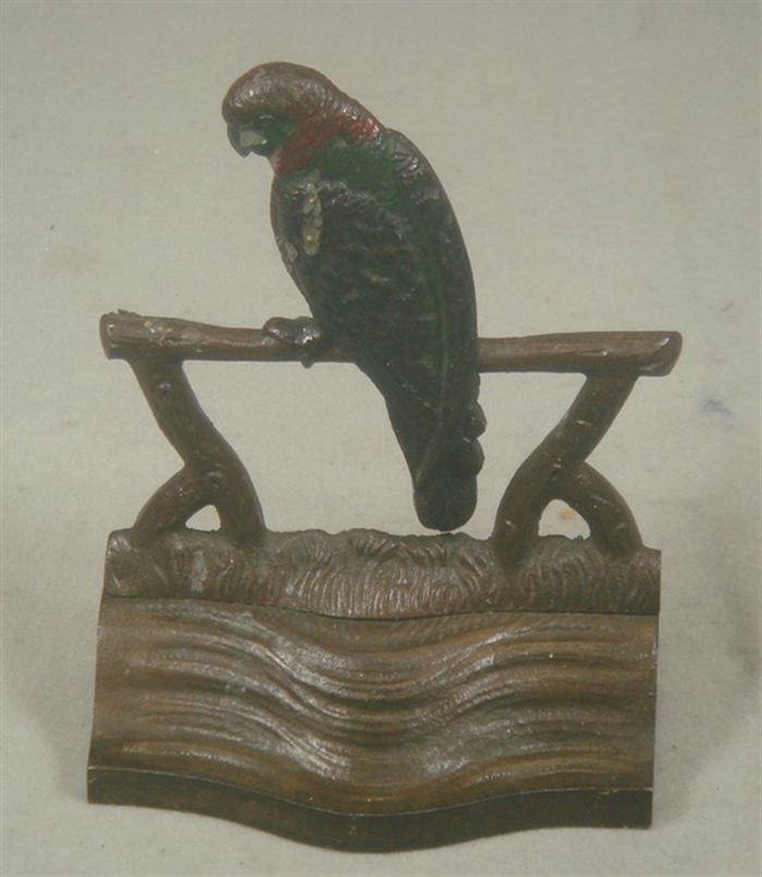 Appraisal: Cast iron doorstop bird on a perch tall x w