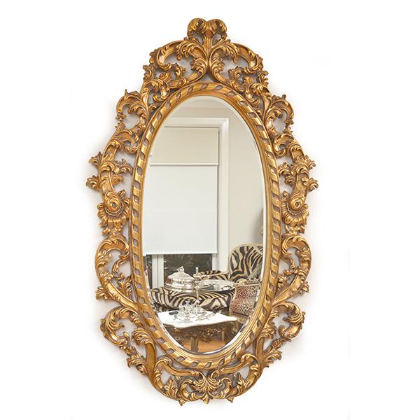 Appraisal: AN OVAL BEVEL EDGED MIRROR WITH A PIERCED GILT WOOD