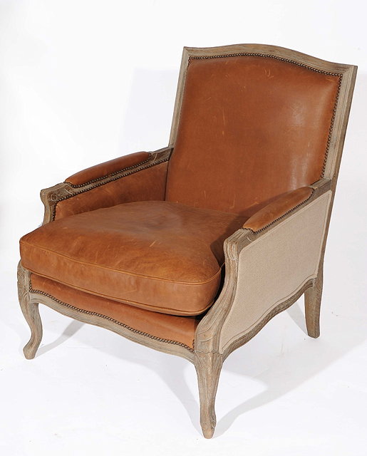 Appraisal: A LARGE FRENCH STYLE LIMED OAK ARMCHAIR with leather and