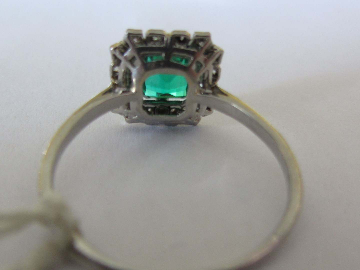 Appraisal: An emerald and diamond set shaped rectangular cluster ring mounted