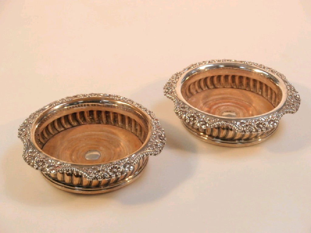 Appraisal: A pair of Victorian silver plated wine coasters each with