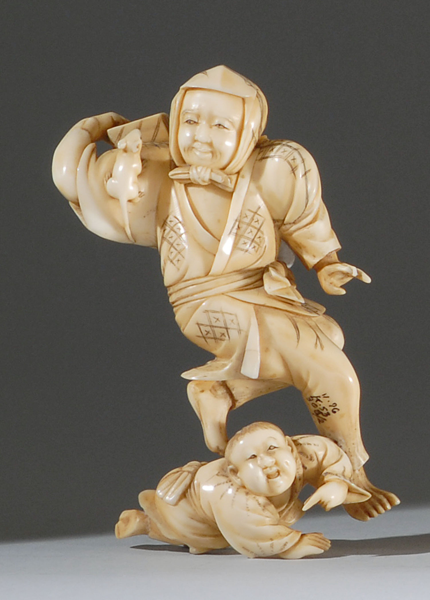 Appraisal: IVORY FIGURE GROUP Meiji PeriodIn the form of a rat