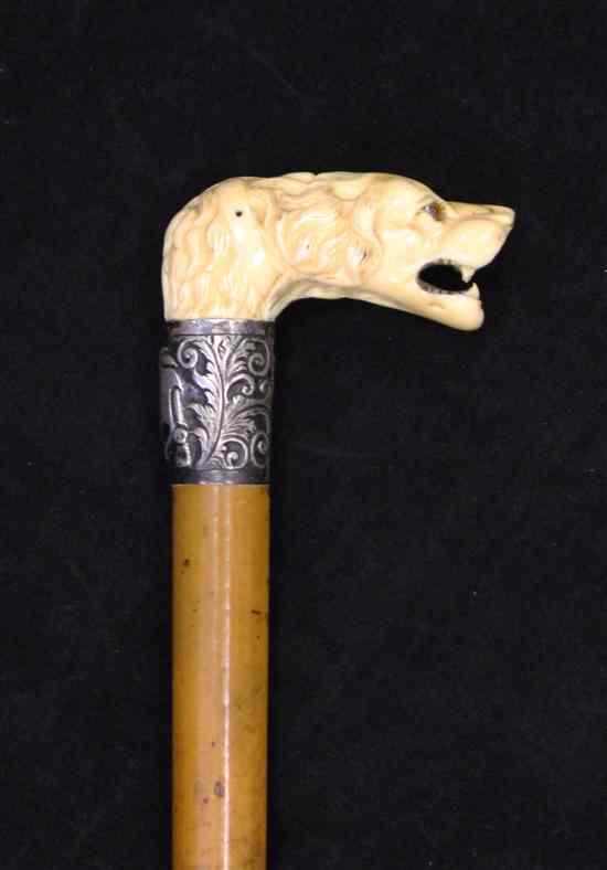 Appraisal: A late th century carved ivory mounted dog head walking