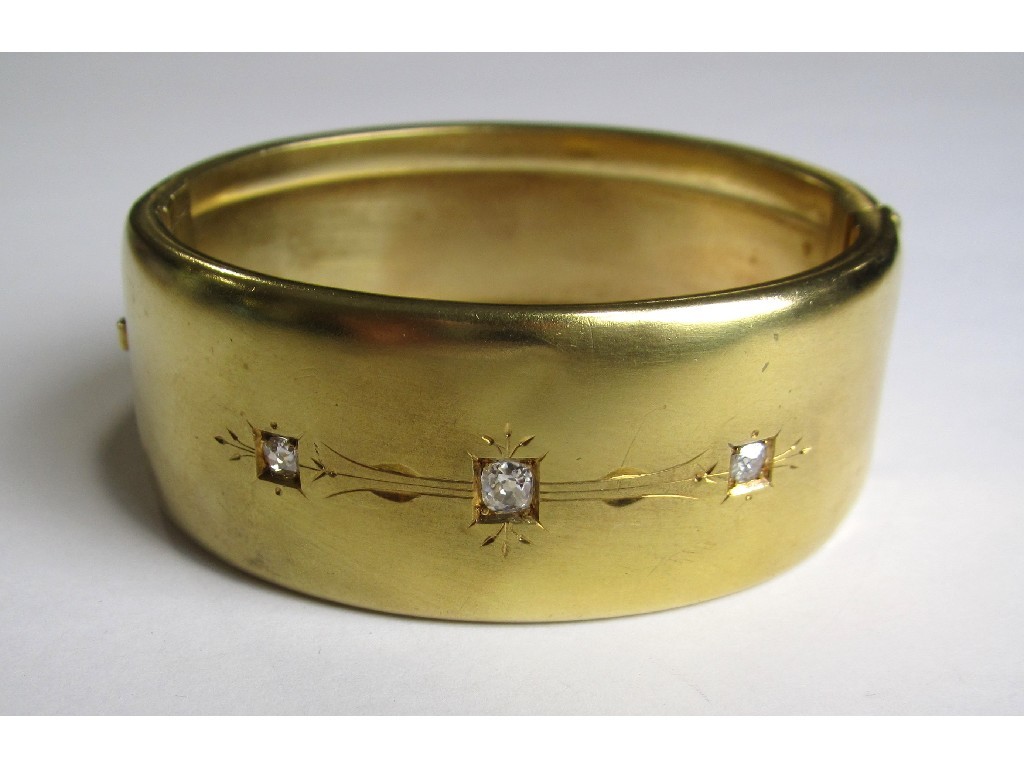 Appraisal: A late Victorian yellow metal diamond set hinged bangle with