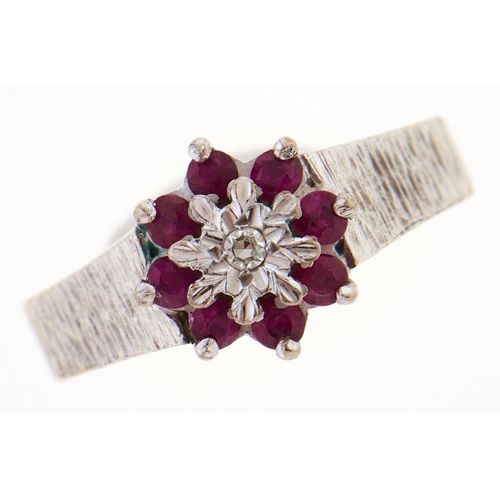 Appraisal: A ruby and diamond cluster ring in white gold with