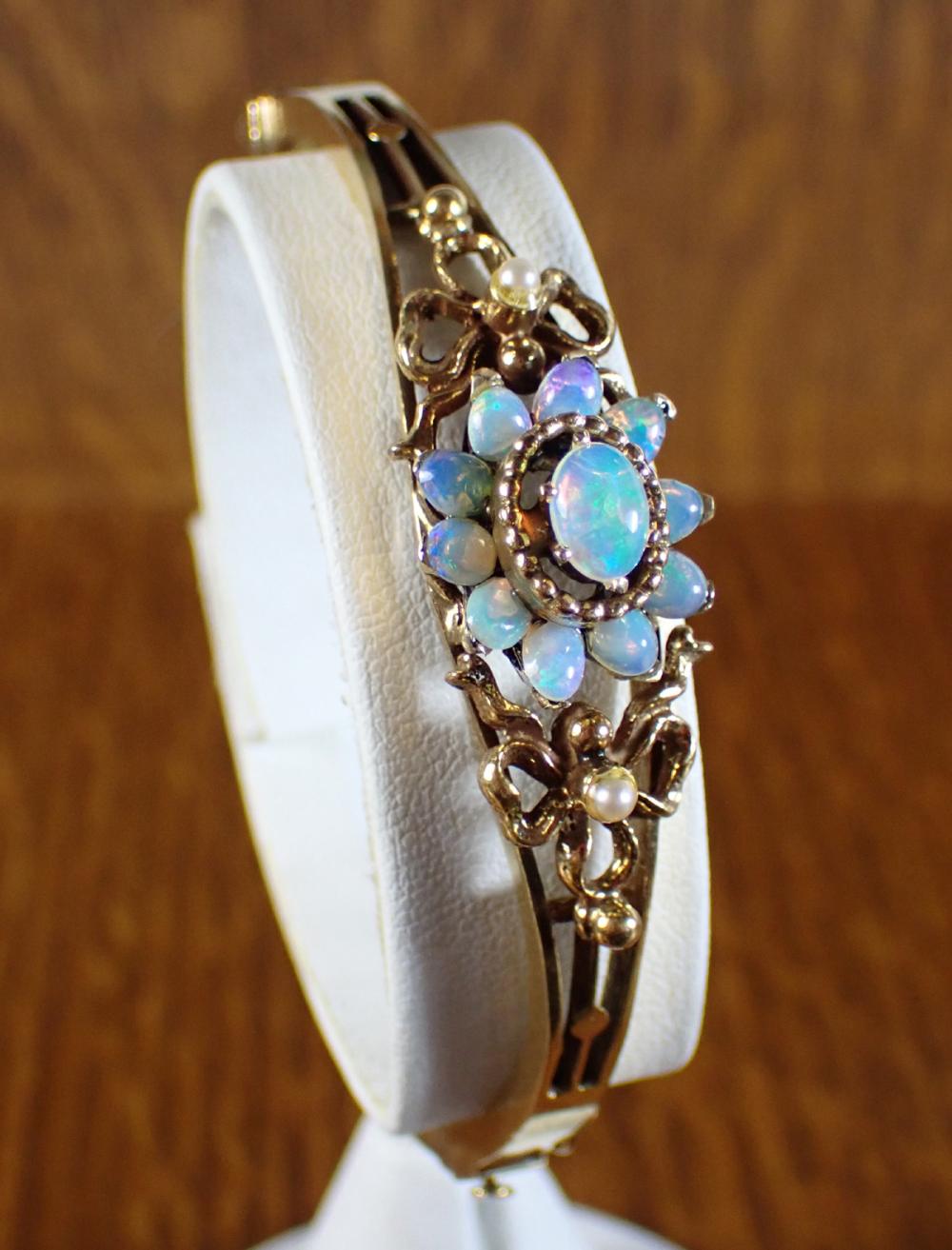 Appraisal: OPAL AND FOURTEEN KARAT GOLD BANGLE The oval hinged k