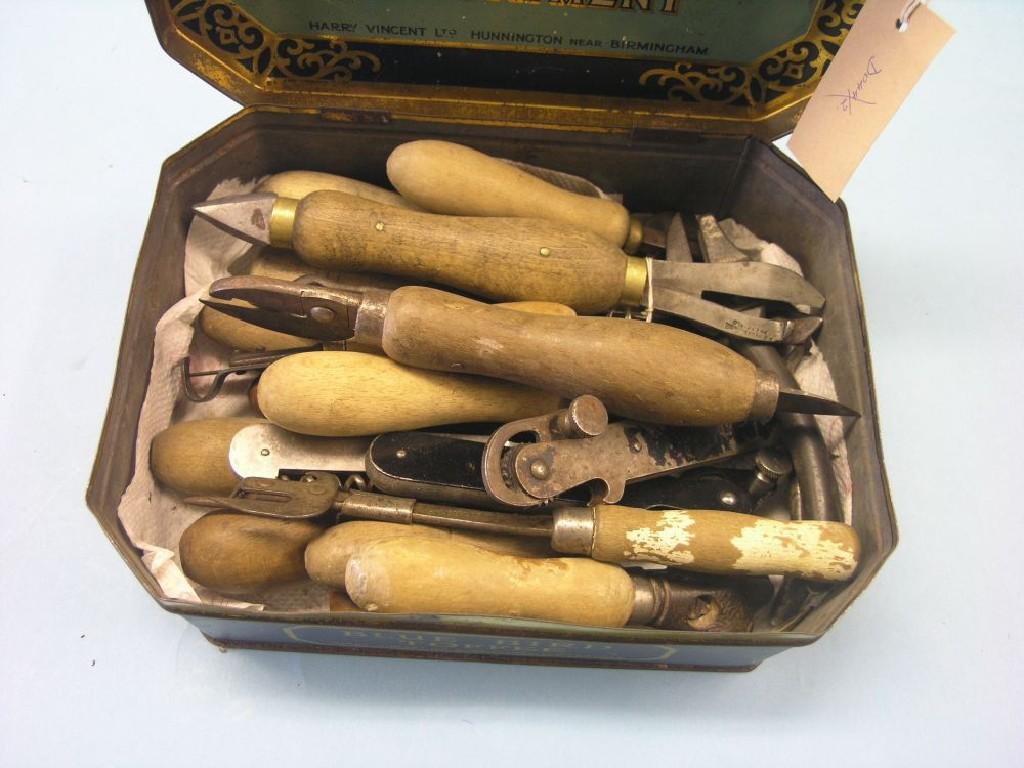 Appraisal: Twenty-one various wood and metal-handled tin openers