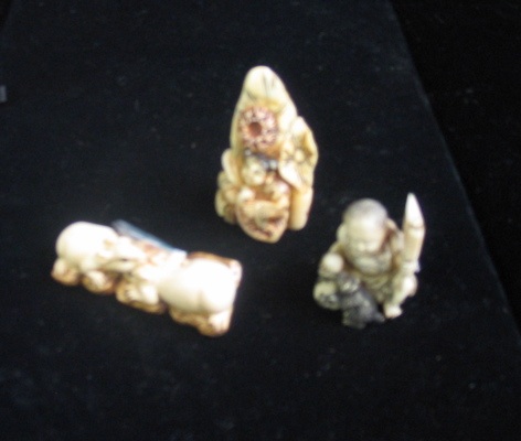 Appraisal: THREE CARVED IVORY OBJECTS Two are Netsuke one with opposing