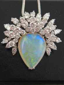 Appraisal: A platinum opal and diamond pendant the pear shaped opal