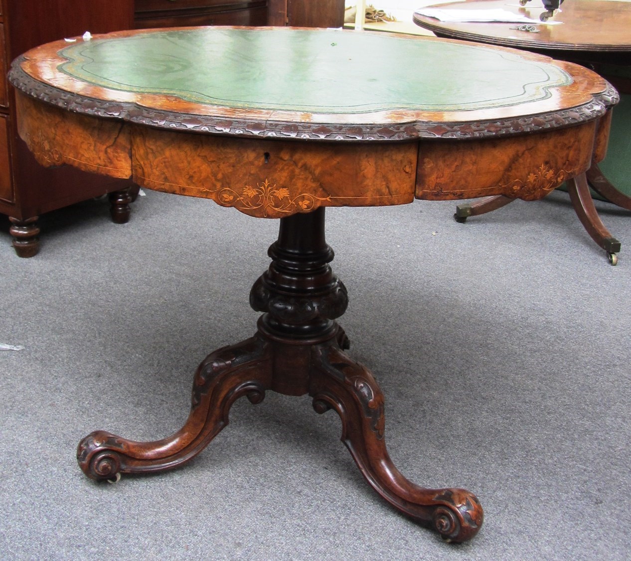 Appraisal: A Victorian mahogany walnut drum table the shaped circular top