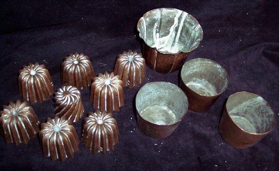 Appraisal: A collection of miniature copper moulds three copper beakers and