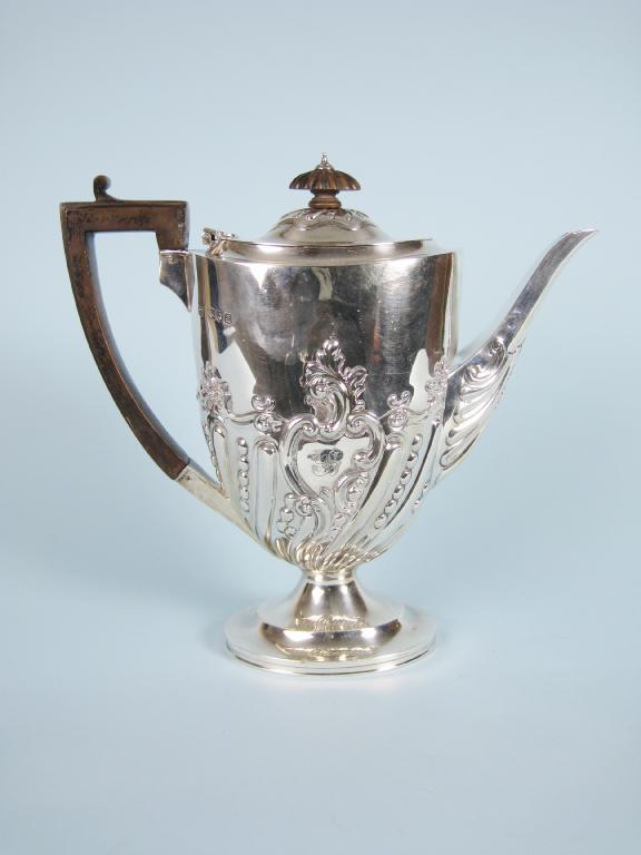 Appraisal: A Victorian oval Coffee Pot with spiral fluting and scroll