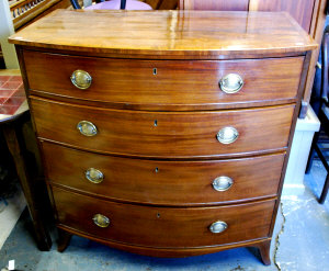 Appraisal: A George III mahogany bowfront chest of four long drawers