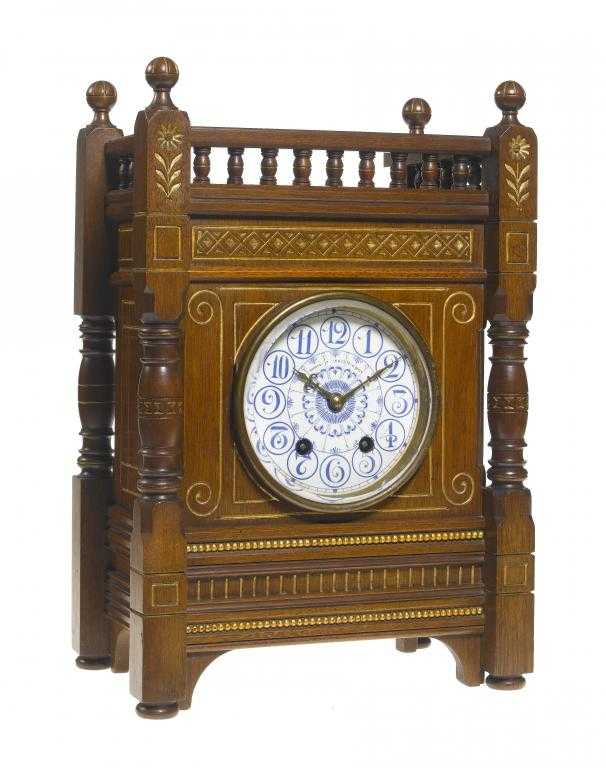 Appraisal: AN AESTHETIC MOVEMENT PARCEL GILT WALNUT CLOCK the white earthenware