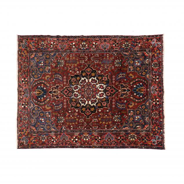 Appraisal: BAKHTIARI CARPET Burgundy field with large poled medallion ground with