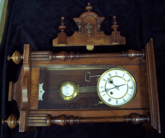 Appraisal: A Vienna type regulator clock in a walnut and stained