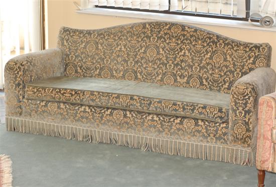 Appraisal: An Upholstered Sofa having a shaped back and upholstered with