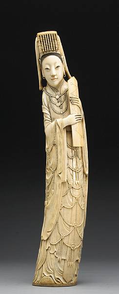 Appraisal: A large carved and tinted ivory figure of a deity