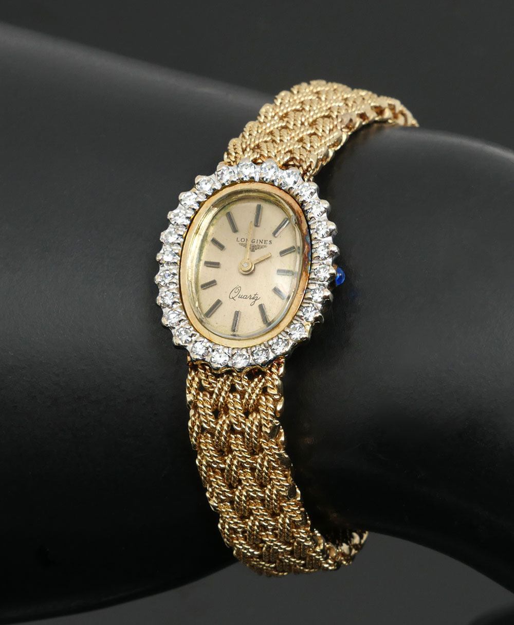 Appraisal: K LONGINES QUARTZ WATCH WITH DIAMOND BEZEL K yellow gold