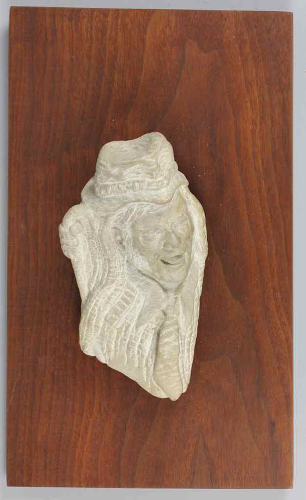 Appraisal: CARVED STONE RELIEF OF A LAUGHING MAN in jaunty hat