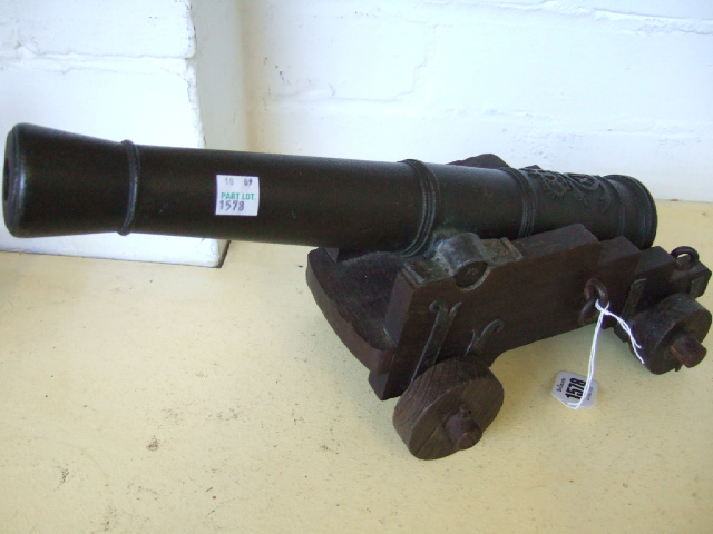 Appraisal: A bronze model of a cannon on a wooden base