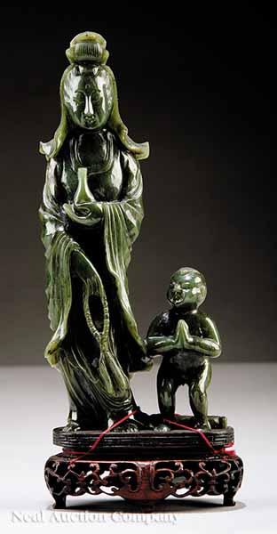 Appraisal: A Chinese Carved Spinach Jade Figural Group of Guanyin th