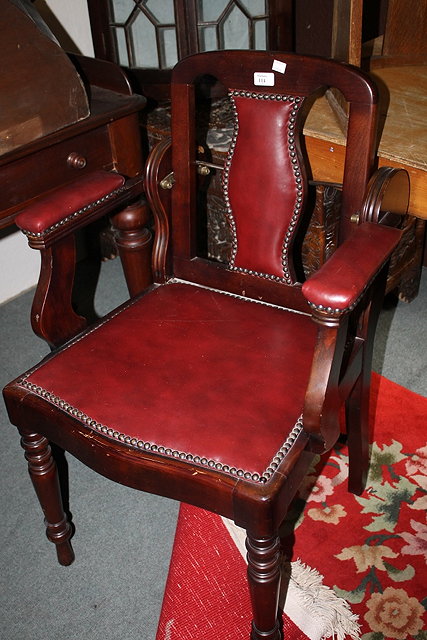 Appraisal: AN EDWARDIAN WALNUT BARBER'S CHAIR with upholstered seat arms and