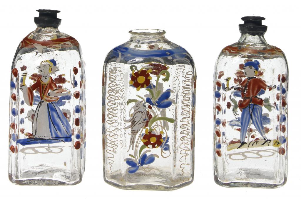 Appraisal: THREE CENTRAL EUROPEAN ENAMELLED BRANDY FLASKS painted in 'peasant style'