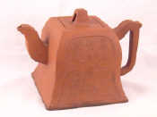 Appraisal: A Chinese red ceramic teapot of square section one side