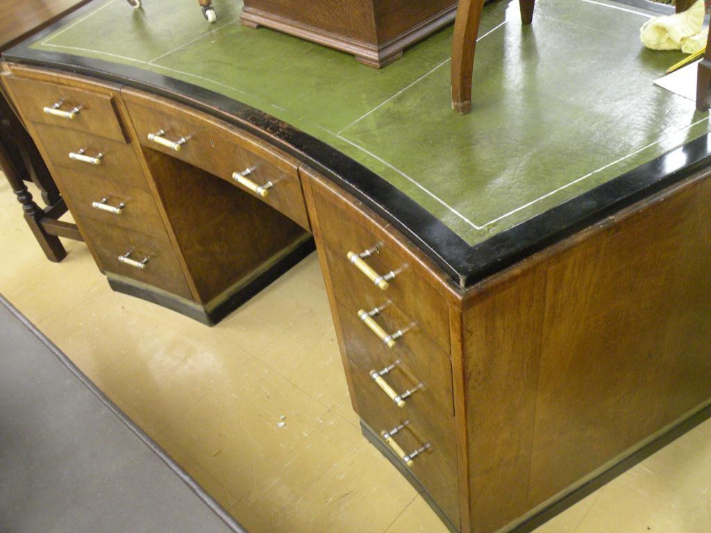 Appraisal: A figured walnut desk of shaped form with leather inset