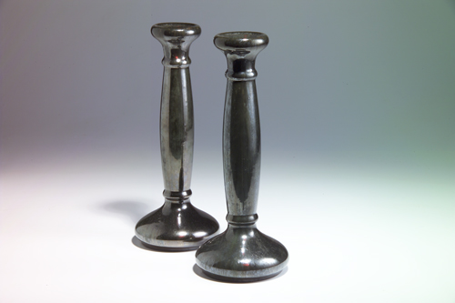 Appraisal: FULPER Pair of tall candlesticks covered in Mirror Black flambe