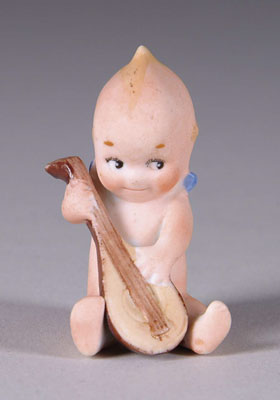 Appraisal: SEATED KEWPIE PLAYING MANDOLIN A charming Kewpie strums her mandolin