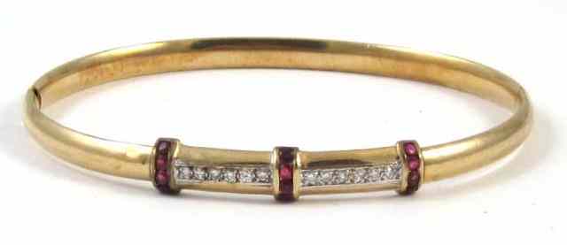 Appraisal: RUBY AND DIAMOND BANGLE k yellow gold set with twelve