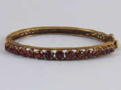 Appraisal: A carat gold garnet bracelet internal width approx mm width