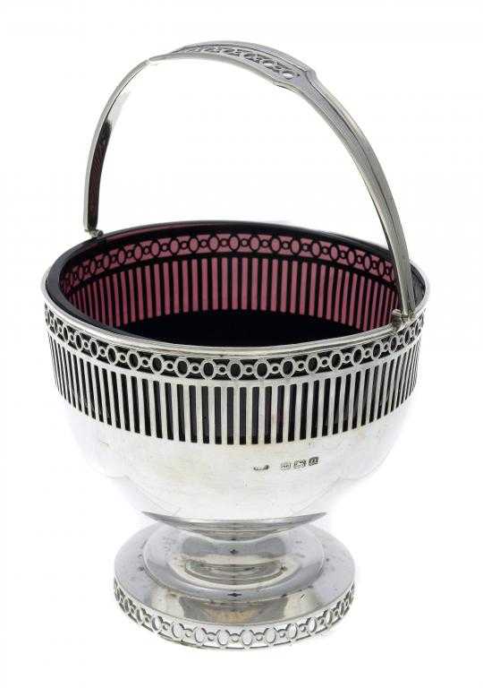 Appraisal: A GEORGE V SUGAR BASKET with swing handle pierced border