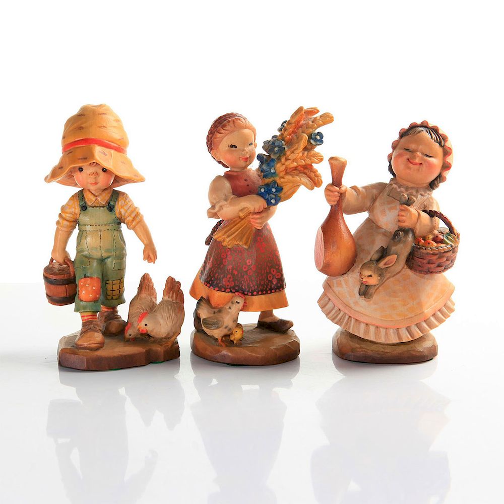 Appraisal: ANRI CARVED WOOD FIGURINES Children with animals farm theme Issued