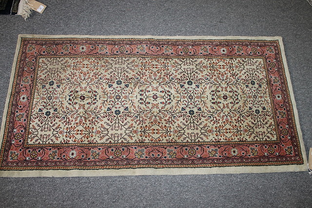 Appraisal: A TUNISIAN BEIGE GROUND SMALL RUG with allover foliate decoration